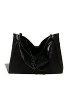 A black slouchy leather shoulder bag with a glossy finish, displayed against a plain white background.