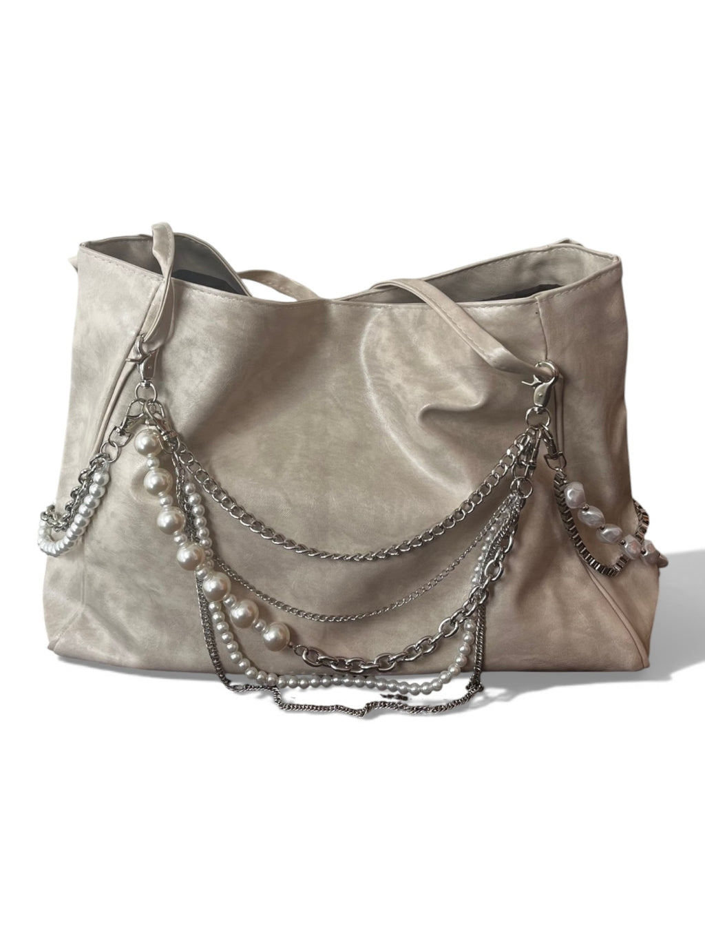 A large taupe faux-leather hobo handbag decorated with silver chains, silver links, and white faux pearls draped over the front, set against a plain white background.