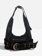 Washed black vegan leather shoulder bag with a chunky eyelet belt and oversized silver buckle on a white background